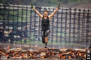 Fanatic Lisa Musacchio strikes a pose over a flaming finish line in her MudGear capri leggings- with pockets, of course. 